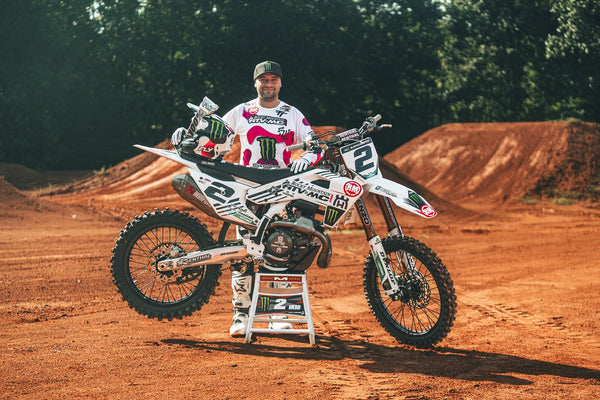 Cooper Webb beside the number 2 Husqvarna in the official Team Tedder partnership photograph; MXoN-era kit